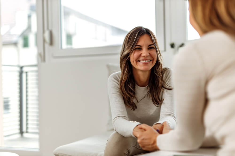 Smiling woman, talking to psychologist