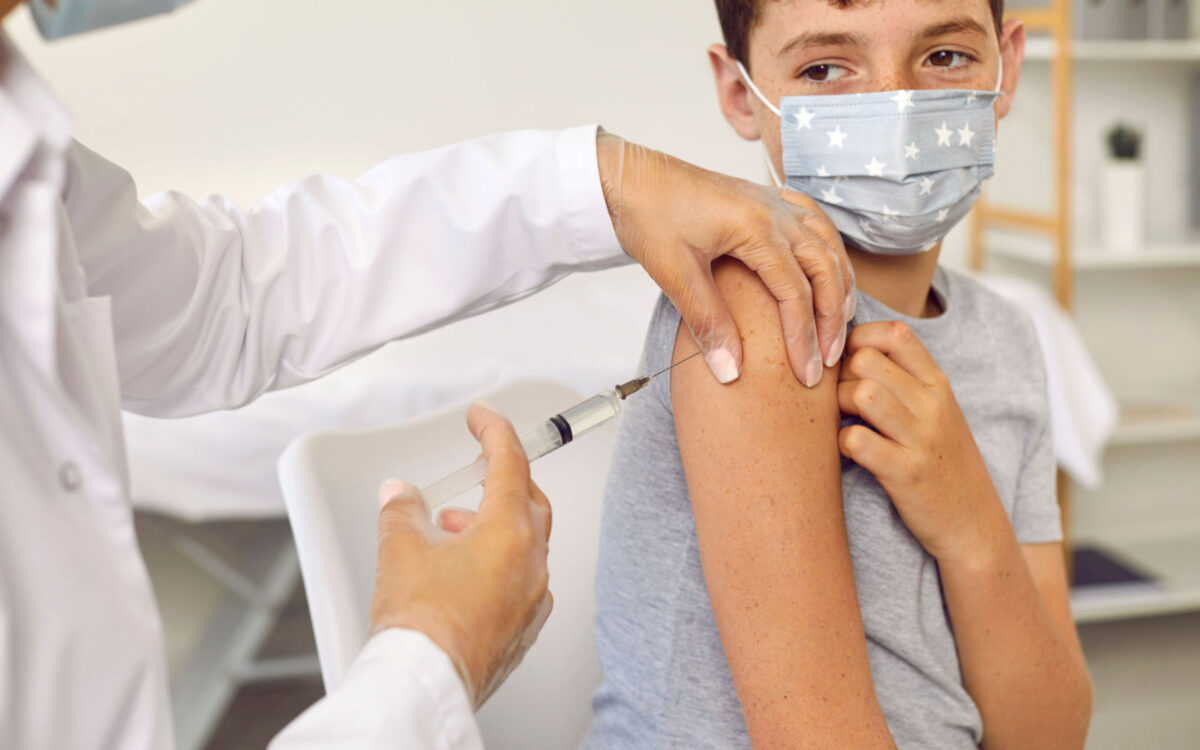 Child Recieving Vaccination From Doctor